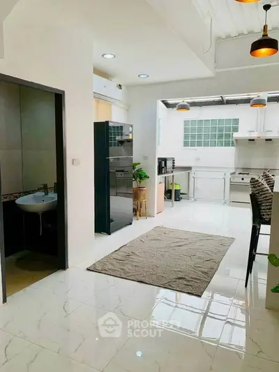 Spacious modern kitchen with sleek appliances and open layout, perfect for culinary enthusiasts.