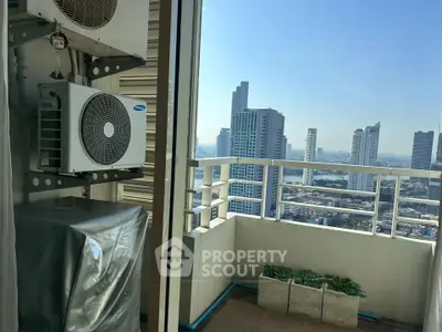 Stunning high-rise balcony with city skyline view and air conditioning units.