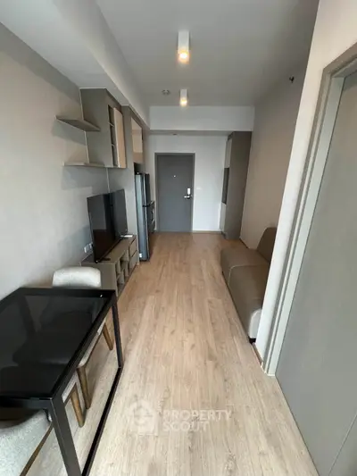Modern apartment interior with sleek furniture and open layout, featuring a stylish living area and dining space.