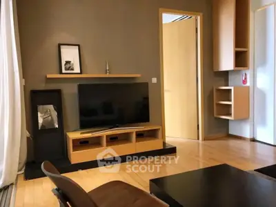 Modern living room with sleek wooden furniture and flat-screen TV, perfect for contemporary urban living.