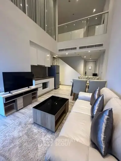 Modern duplex living room with high ceilings and sleek furnishings