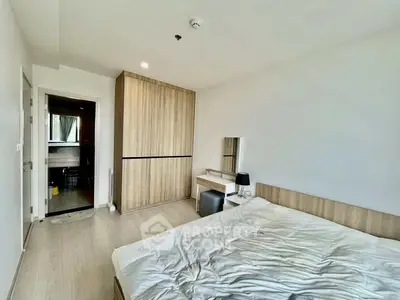 Spacious bedroom with modern wooden wardrobe and cozy bed setup