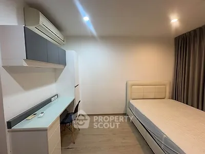 Modern bedroom with minimalist design, featuring a bed, desk, and air conditioning unit.