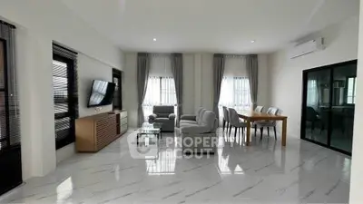 Spacious modern living room with elegant dining area and sleek marble flooring.