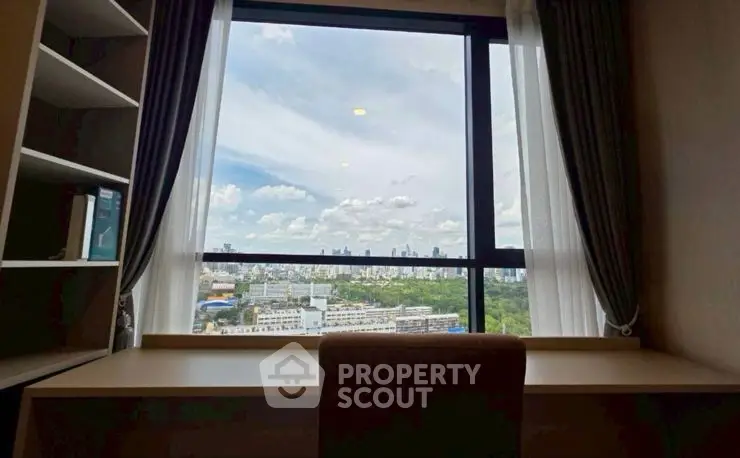 Stunning panoramic city view from a modern high-rise apartment window.