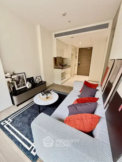 Modern living room with stylish decor and open layout, featuring a cozy sofa and elegant furnishings.