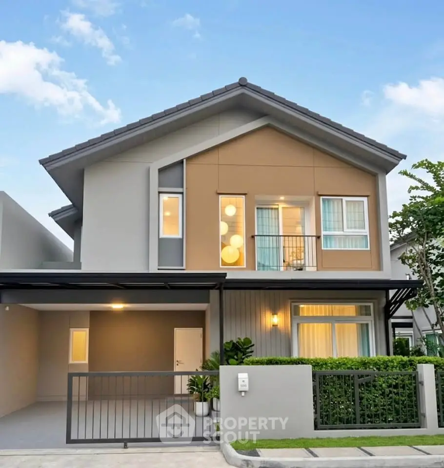 Modern two-story house with stylish facade and well-maintained garden, perfect for family living.