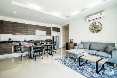 Modern open-plan living room and kitchen with sleek furniture and stylish decor
