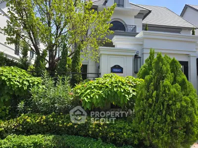Elegant suburban home with lush garden and classic architecture