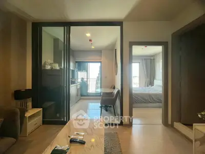 Modern apartment interior with open layout, featuring a cozy living room, sleek kitchen, and inviting bedroom.