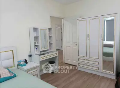 Elegant bedroom with stylish white furniture and wooden flooring