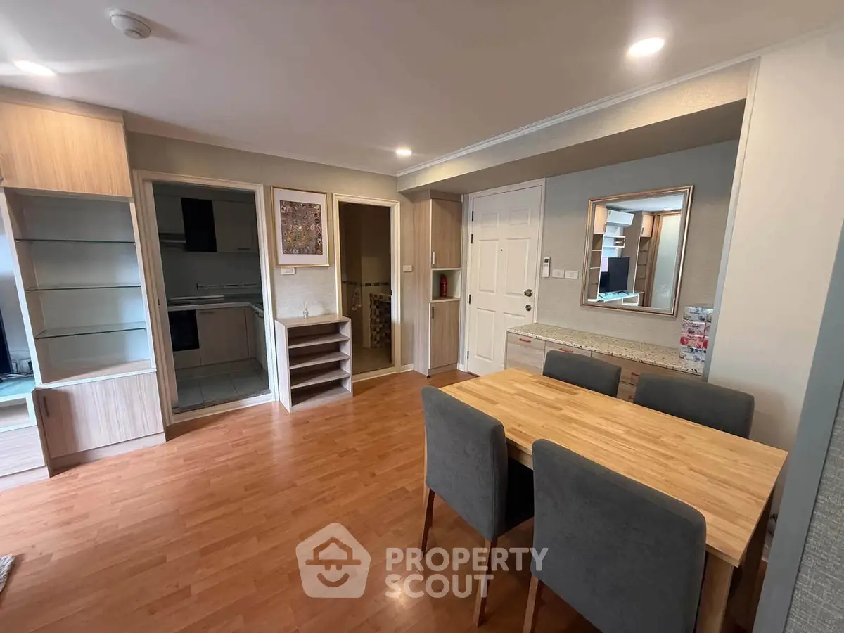 Spacious living room with dining area and modern decor in a stylish apartment.