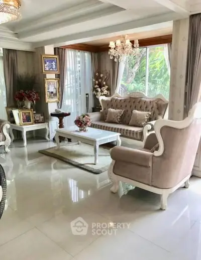 Elegant living room with classic furniture and large windows for natural light.
