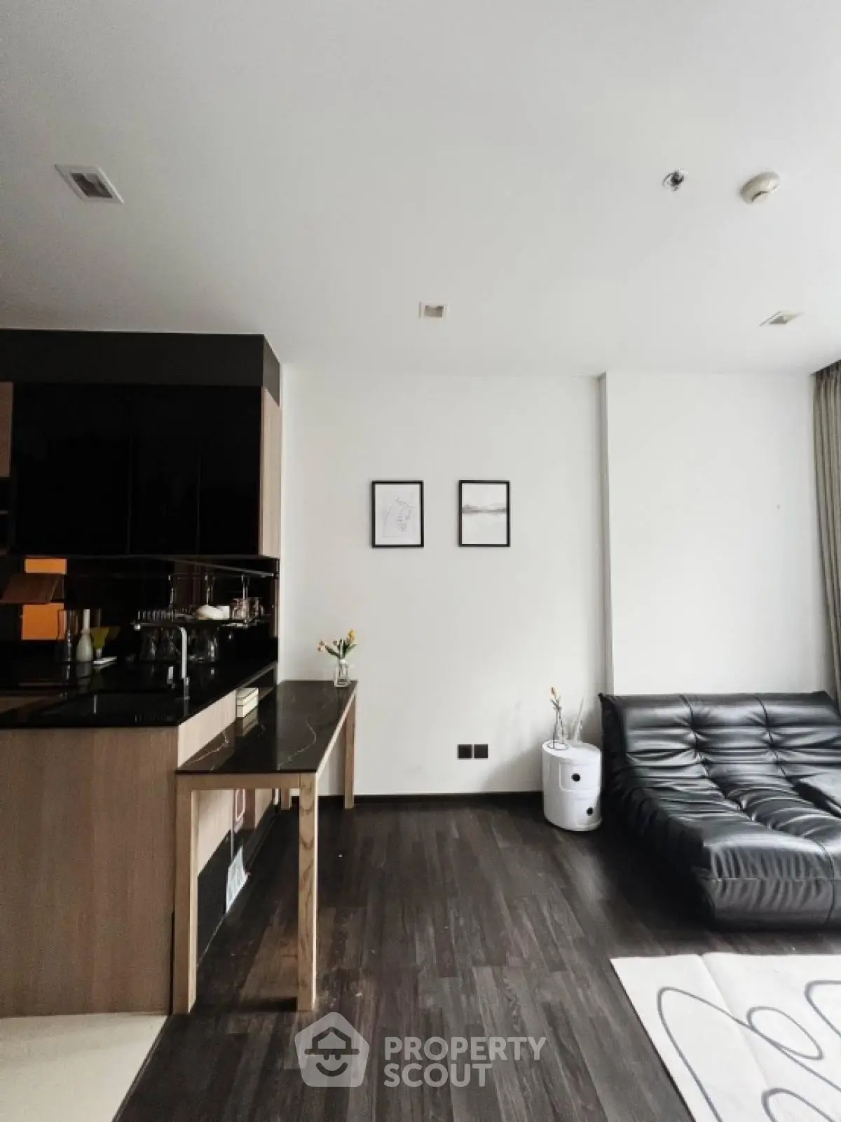 Modern living room with sleek black sofa and minimalist decor