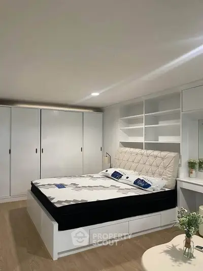 Modern bedroom with stylish bed, built-in wardrobes, and elegant decor