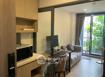 Modern studio apartment with cozy living area and balcony view