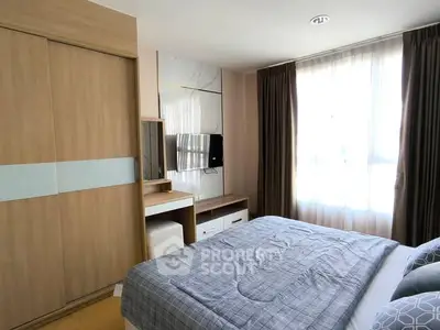 Cozy bedroom with modern decor, large window, and built-in wardrobe in a stylish apartment.