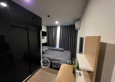 Modern bedroom with sleek black wardrobe and cozy bed in stylish apartment.