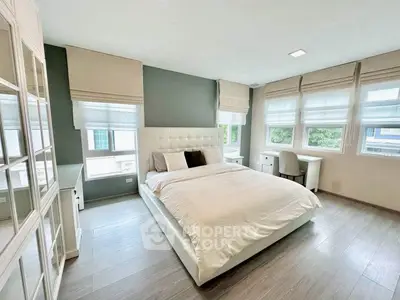 Spacious modern bedroom with large windows and elegant decor
