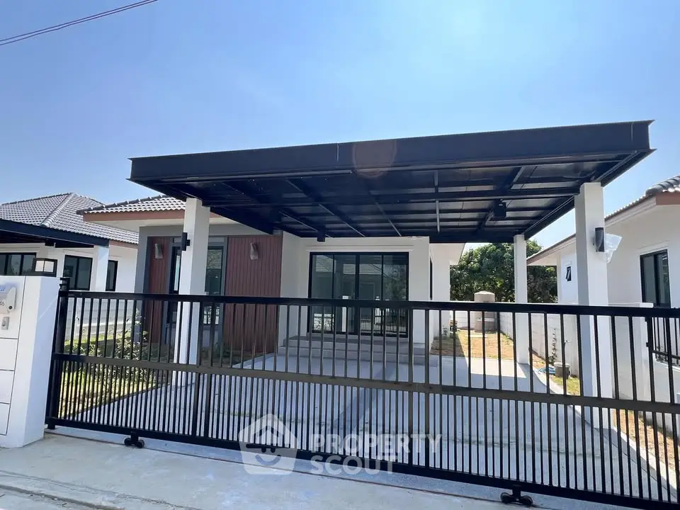 Modern single-story house with sleek carport and gated entrance in a sunny neighborhood.