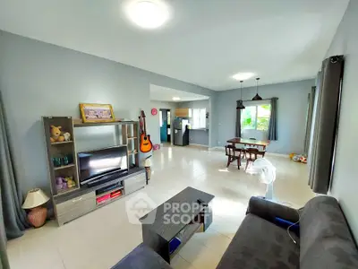 Spacious living room with modern decor and natural light, perfect for family gatherings.