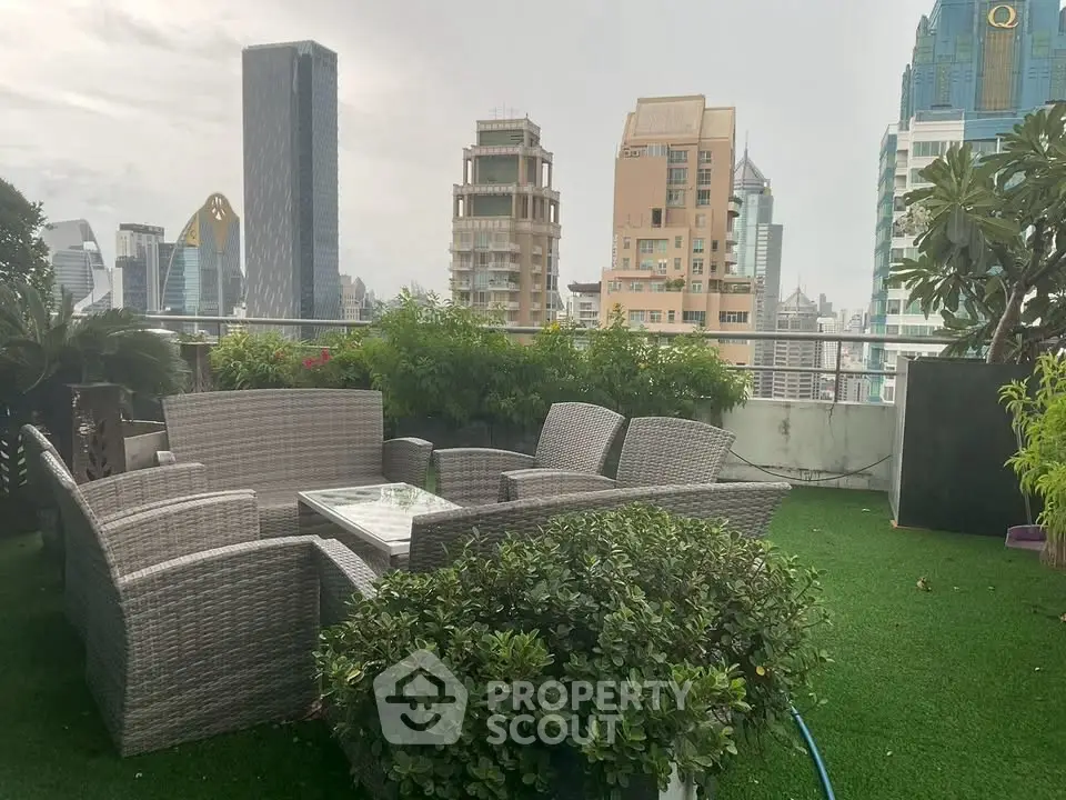 Stunning rooftop garden with city skyline views and cozy seating area.