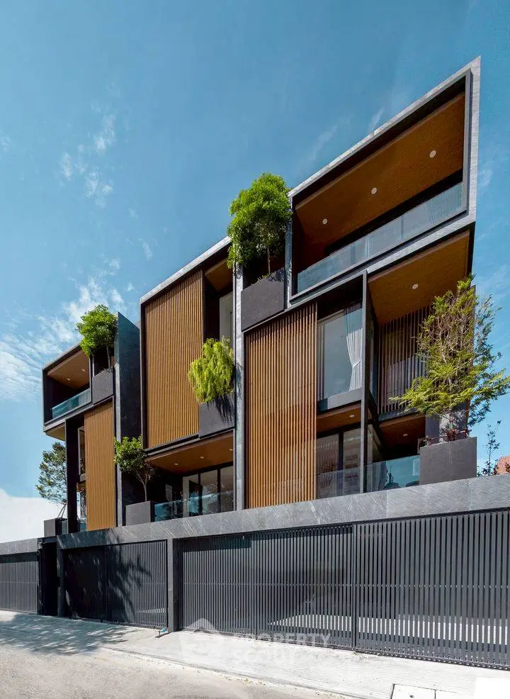 Stunning modern architectural building with lush greenery and sleek design.