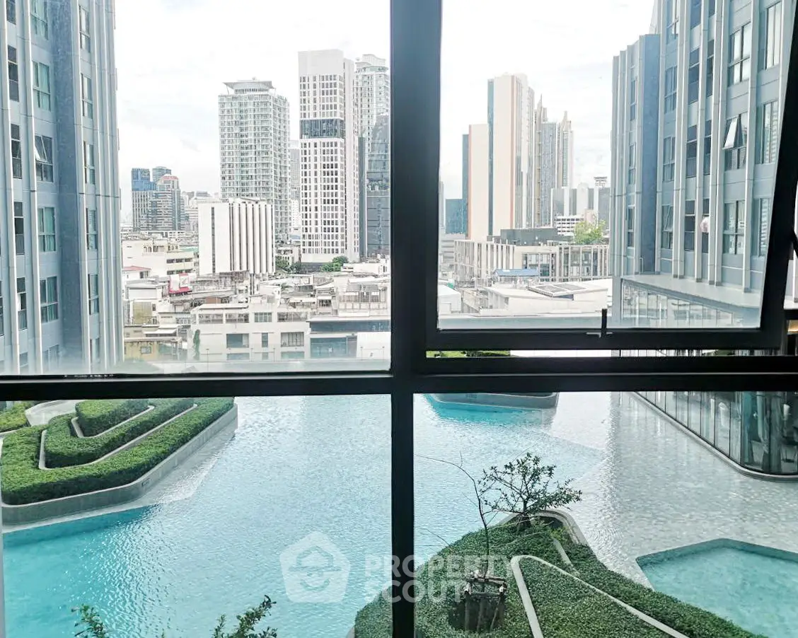 Stunning urban view from high-rise with modern pool and lush greenery