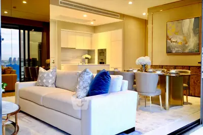 Luxurious open-plan living room with elegant dining area and modern kitchen, featuring city views.