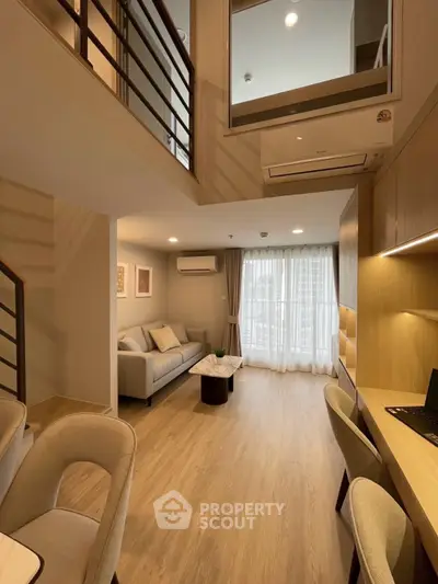 Modern duplex living room with stylish furniture and natural light