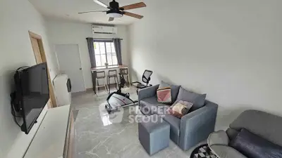 Modern living room with exercise bike and stylish decor