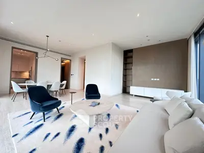 Spacious modern living room with elegant decor and open dining area, perfect for luxury living.