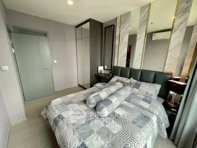 Modern bedroom with stylish decor and ample natural light, featuring a comfortable bed and sleek wardrobe.
