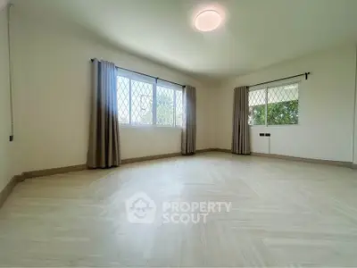 Spacious and bright corner unit with large windows and elegant flooring, perfect for modern living.