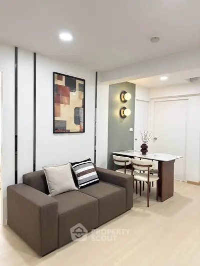 Modern living room with stylish decor and dining area in a cozy apartment.