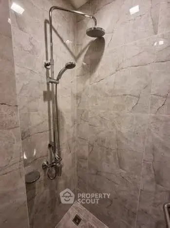 Modern bathroom shower with sleek marble tiles and dual showerheads