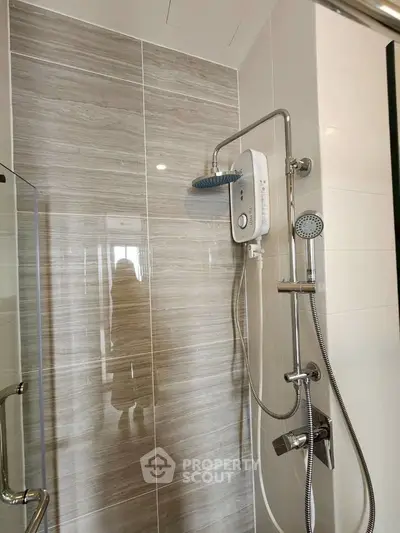 Modern bathroom with sleek shower fixtures and glass enclosure