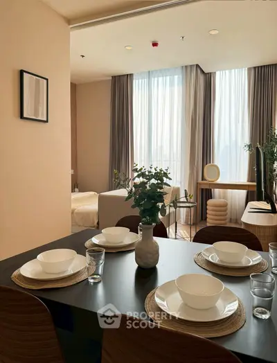 Modern dining area with elegant table setting and cozy bedroom view