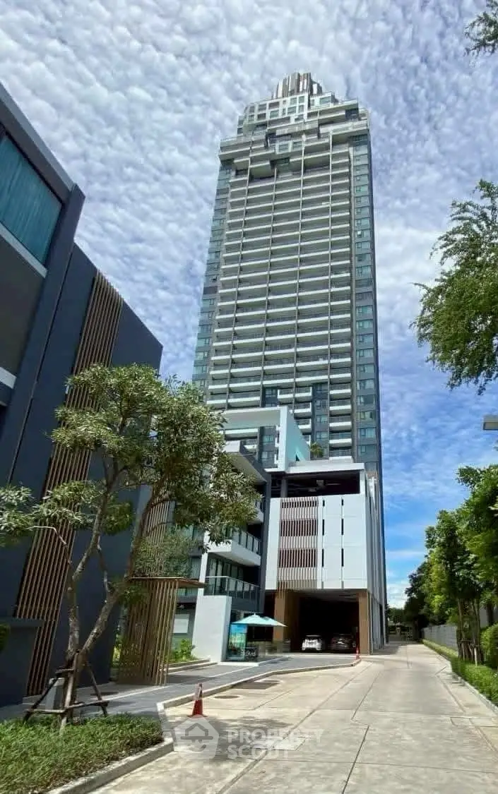 Stunning modern high-rise building with sleek design and lush surroundings, perfect for urban living.