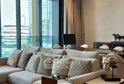 Luxurious living room with modern decor and stunning city view, featuring elegant furniture and floor-to-ceiling windows.