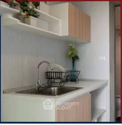 Modern compact kitchen with sleek cabinetry and stylish sink area