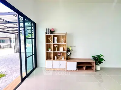 Modern living room with stylish shelving and large glass doors opening to a patio, perfect for natural light lovers.