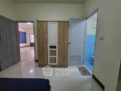 Spacious bedroom with wardrobe and ensuite bathroom in modern apartment