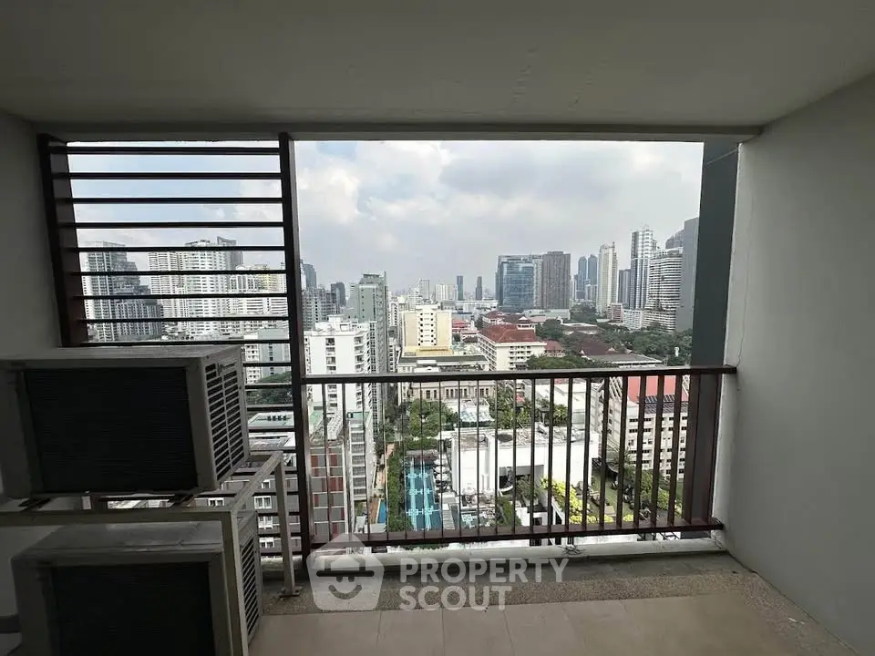 Stunning cityscape view from a high-rise balcony with modern urban skyline.