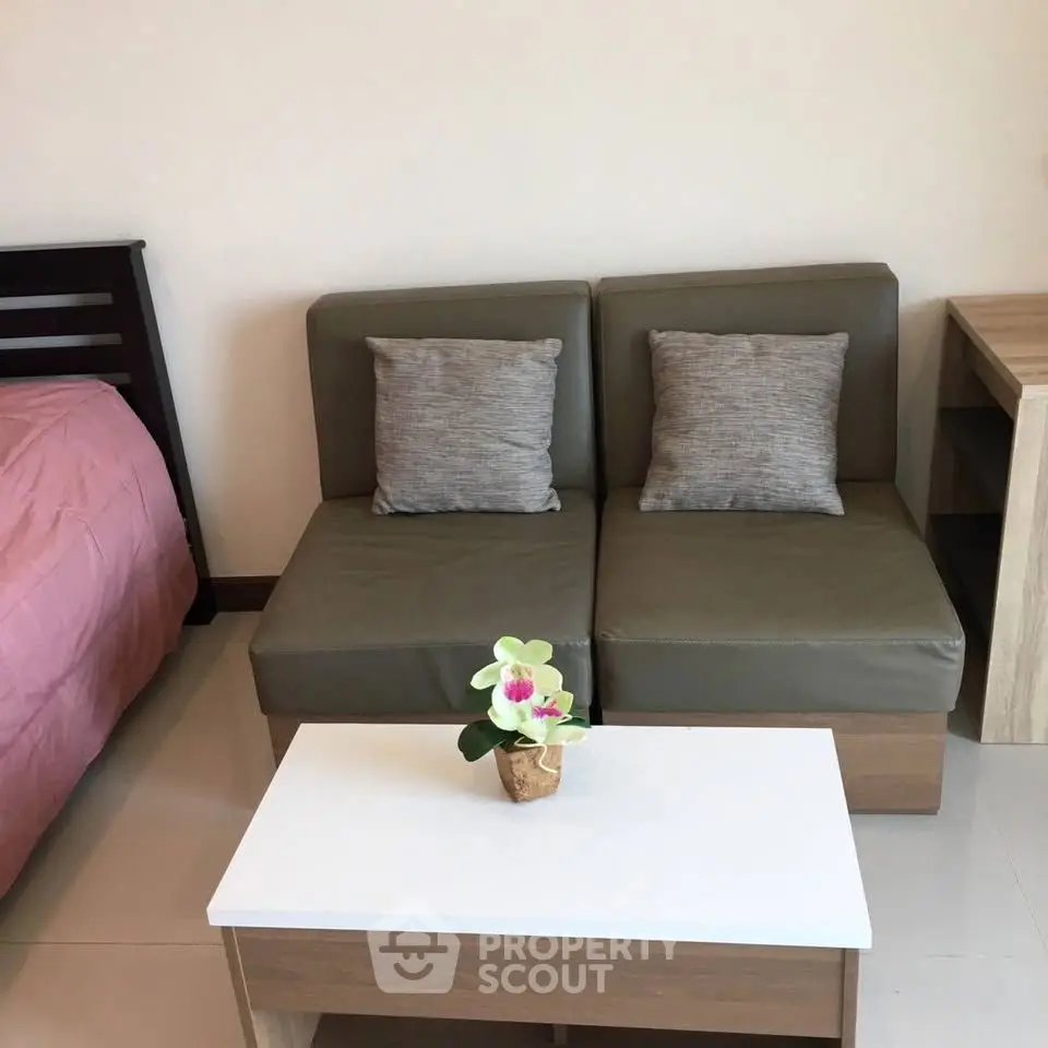 Cozy living area with modern sofa and coffee table in stylish apartment.