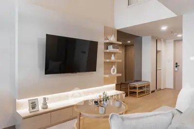 Modern living room with stylish decor and wall-mounted TV in a cozy apartment.