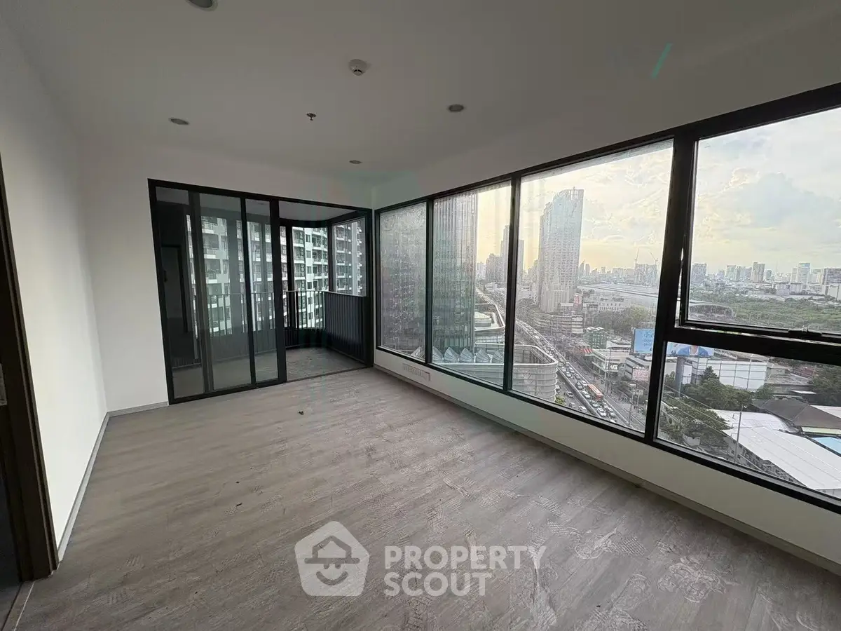 Spacious corner unit with floor-to-ceiling windows offering stunning city views, perfect for modern living.