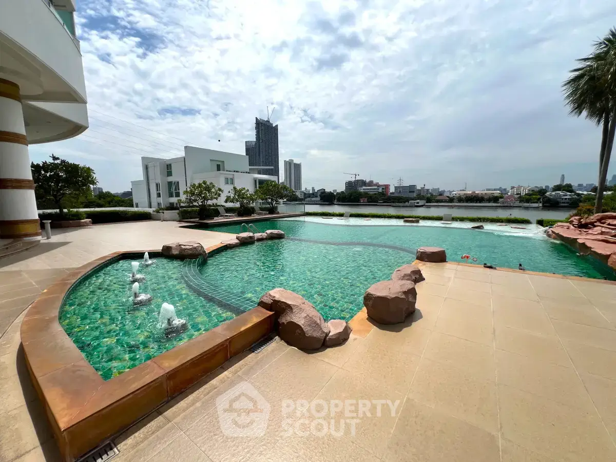 Luxurious outdoor pool area with stunning cityscape view, perfect for relaxation and leisure in a modern residential complex.