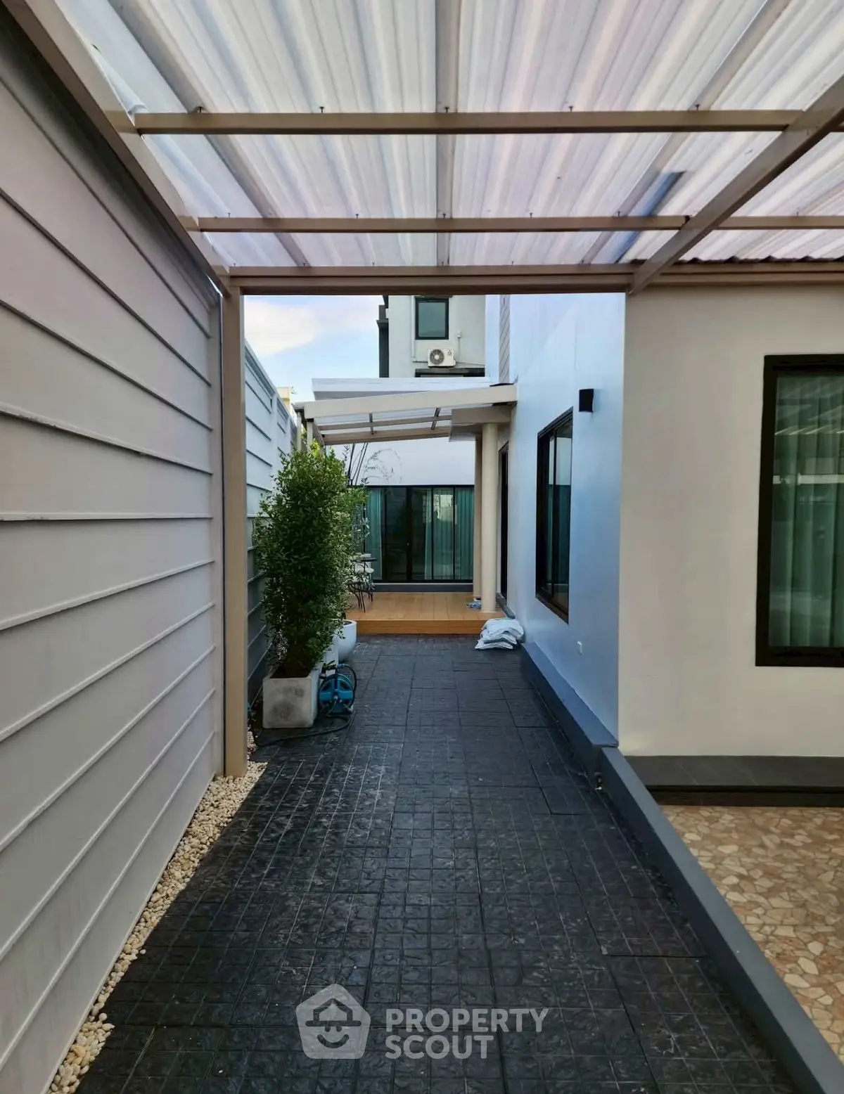 Modern home exterior with covered walkway and sleek design elements