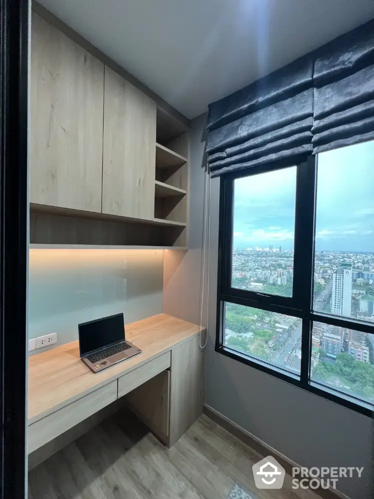 Modern study room with wooden desk and cabinets offering stunning city view.